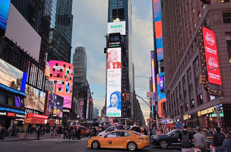 A billboard in Times Square showing live election odds on October 10.